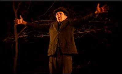 A young man turning his back to the woods in "The Village"